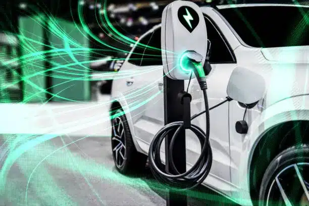 white electric vehicle plugged in